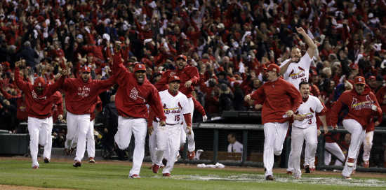 St. Louis Cardinals Albert Pujols celebrates after scoring off of a David  Freese triple against the Texas Rangers during the 9th inning of game 6 of  the World Series in St. Louis