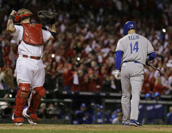 St. Louis Cardinals manager Mike Matheny holds up the championship trophy  after Game 6 of the National League baseball championship series against  the Los Angeles Dodgers Friday, Oct. 18, 2013, in St.